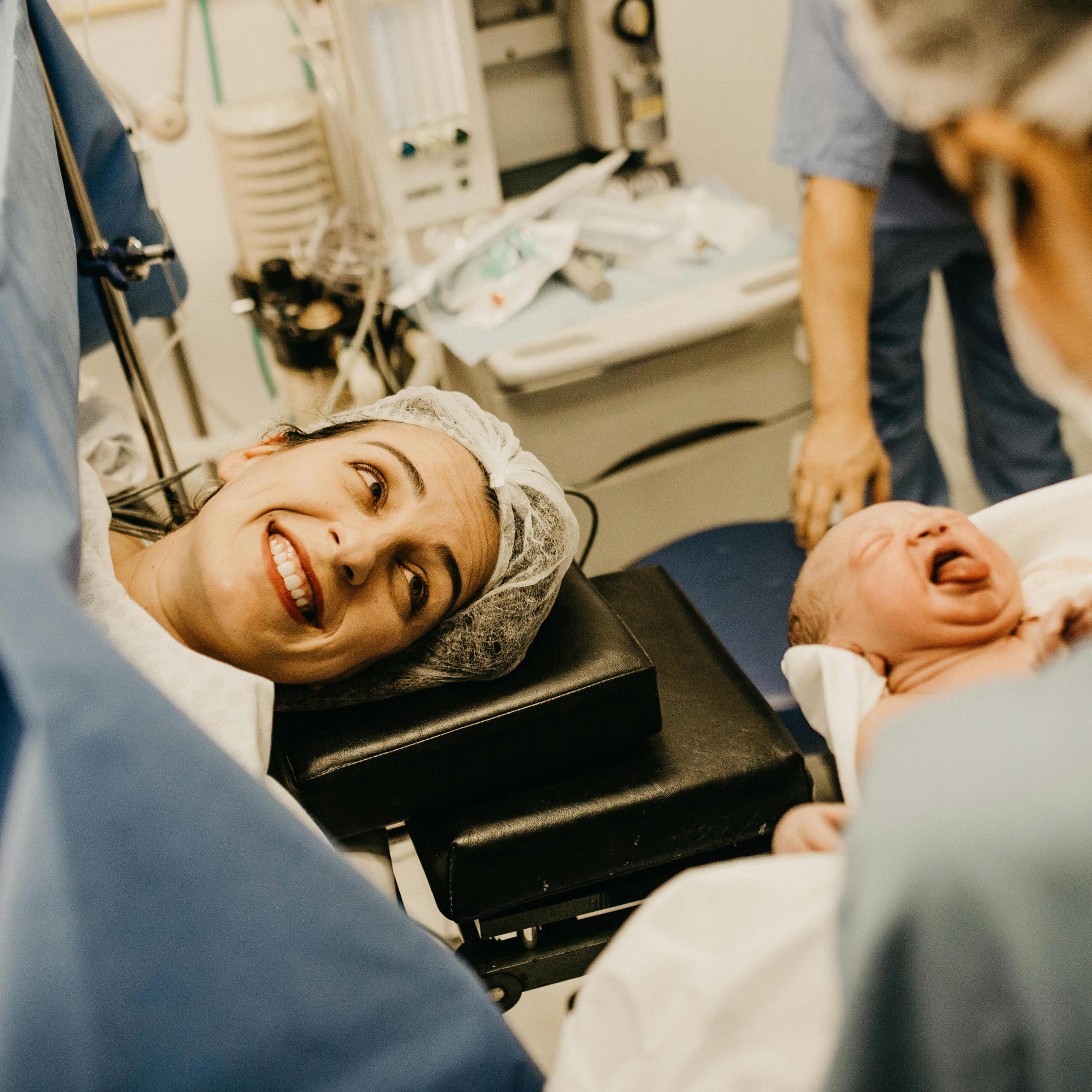 Mother smiles at her new baby