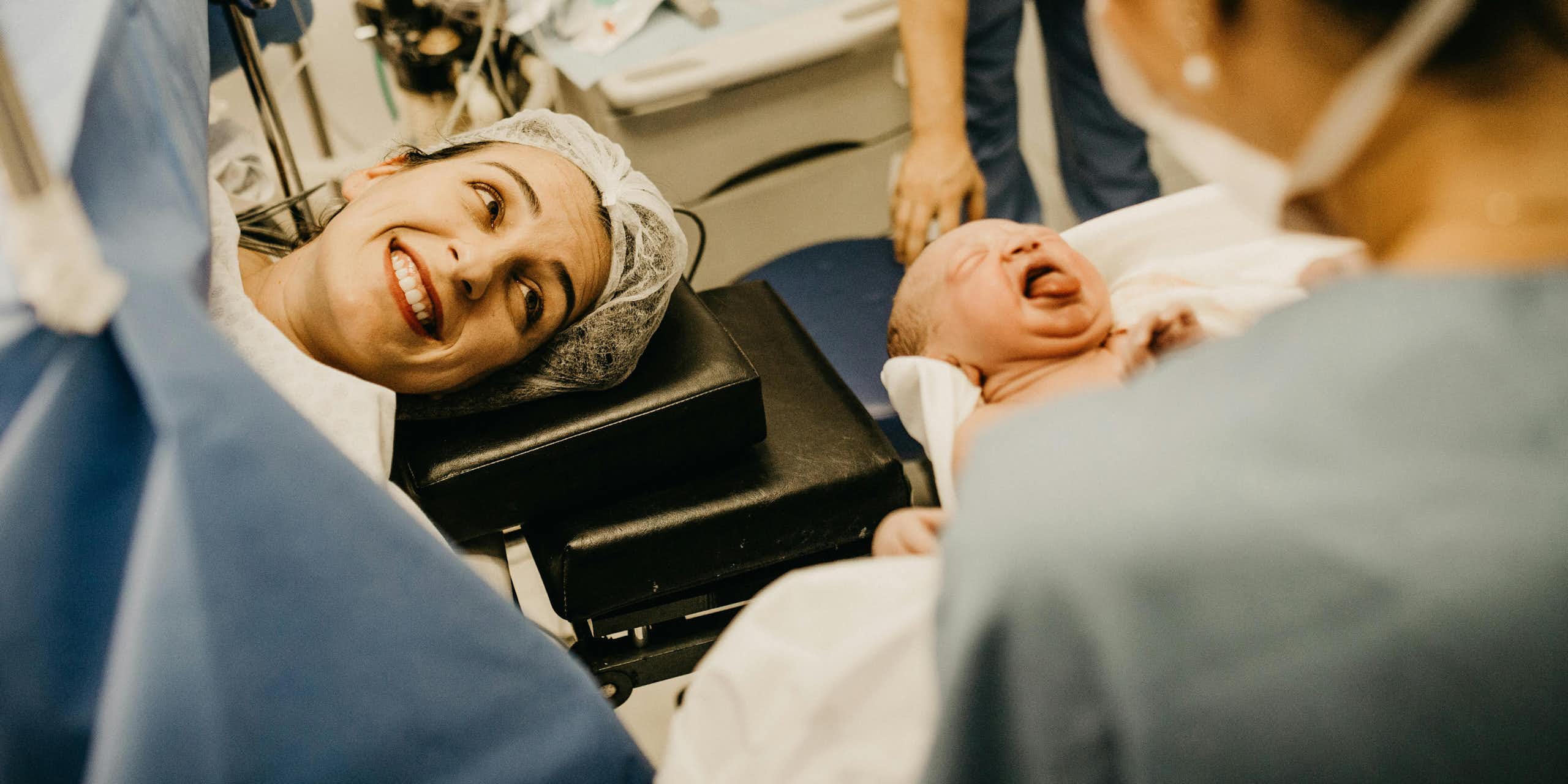 Mother smiles at her new baby