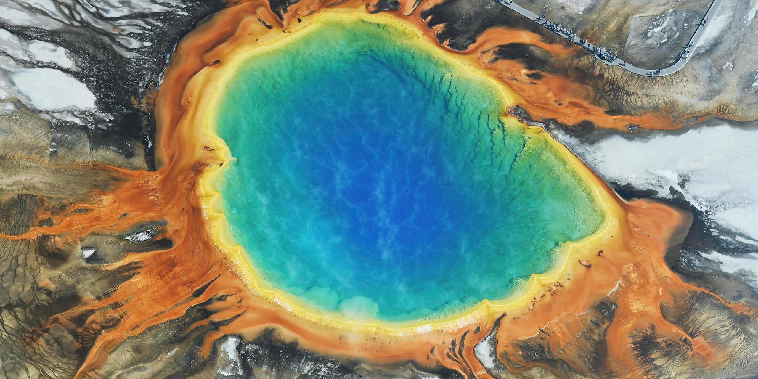 Aerial photo of a multicoloured pool of water among rocks