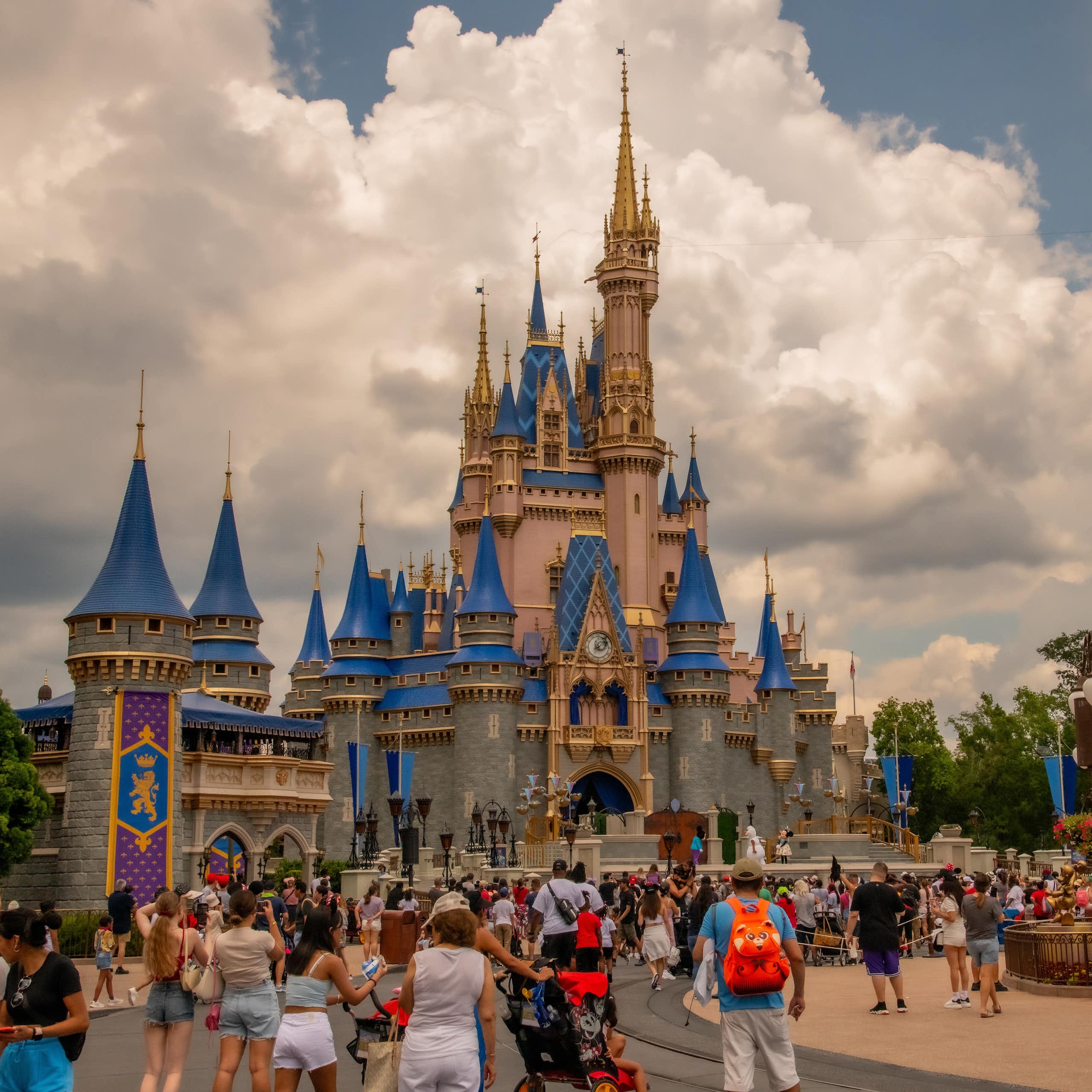 people walk near Cinderella's Castle at Disney world 