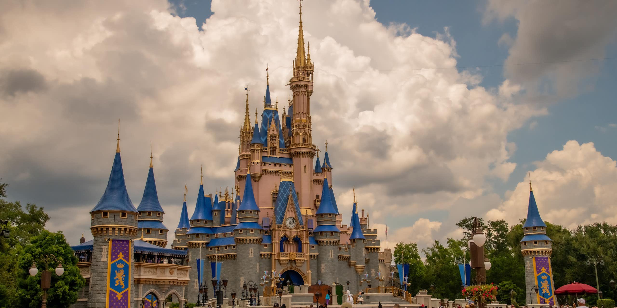 people walk near Cinderella's Castle at Disney world 