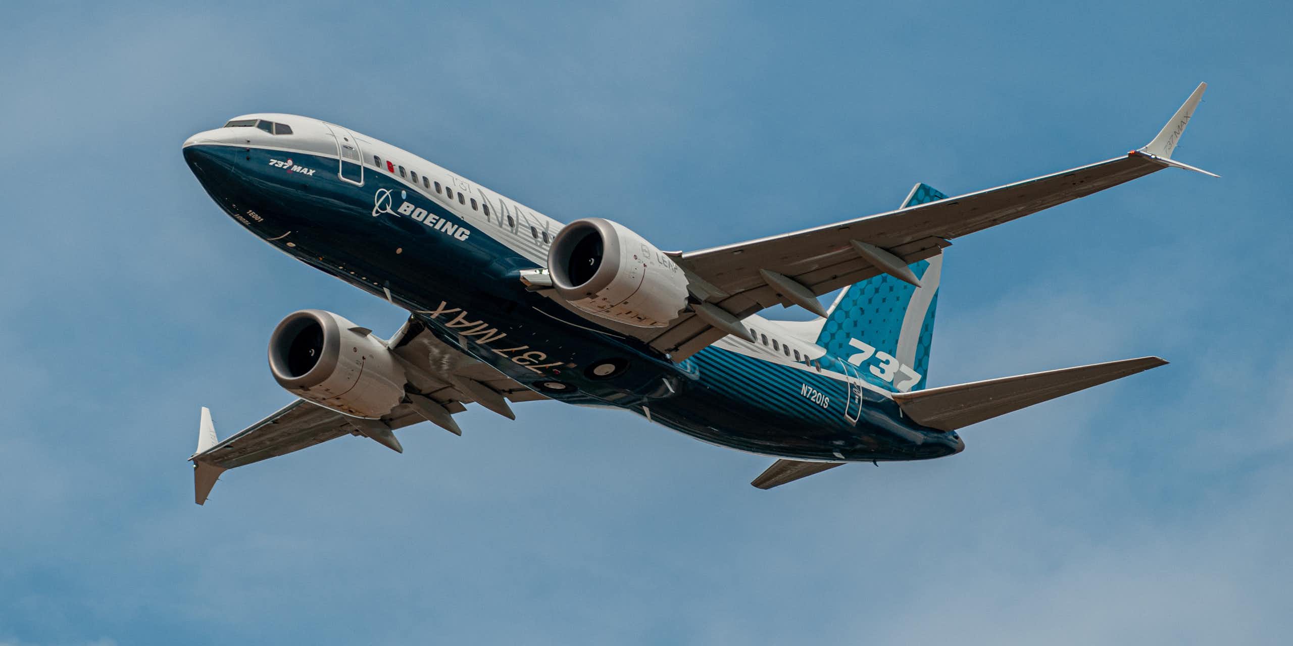 Upward shot of the underside of an airplane flying through the air