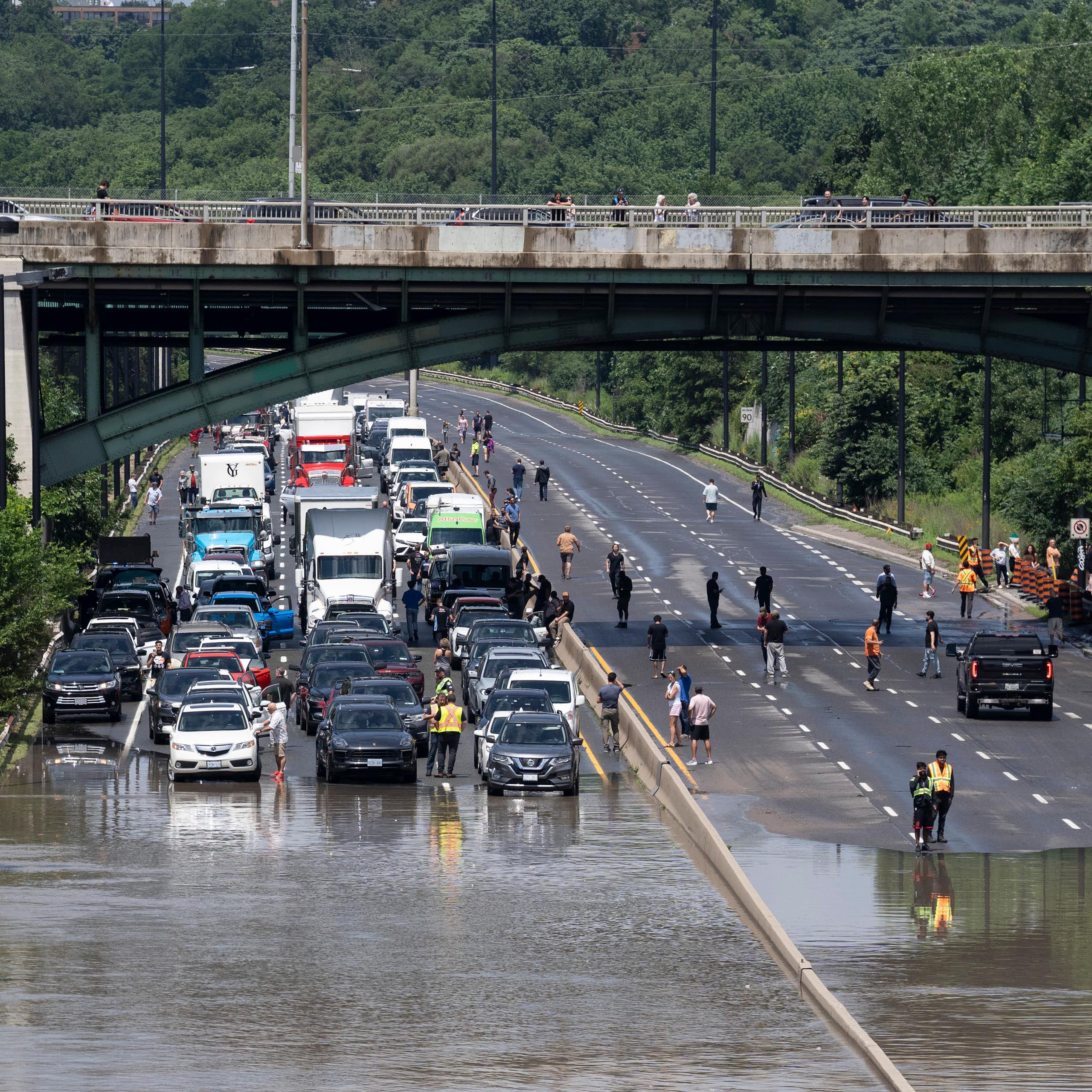 A back up of cars is seen on a flooded highway.