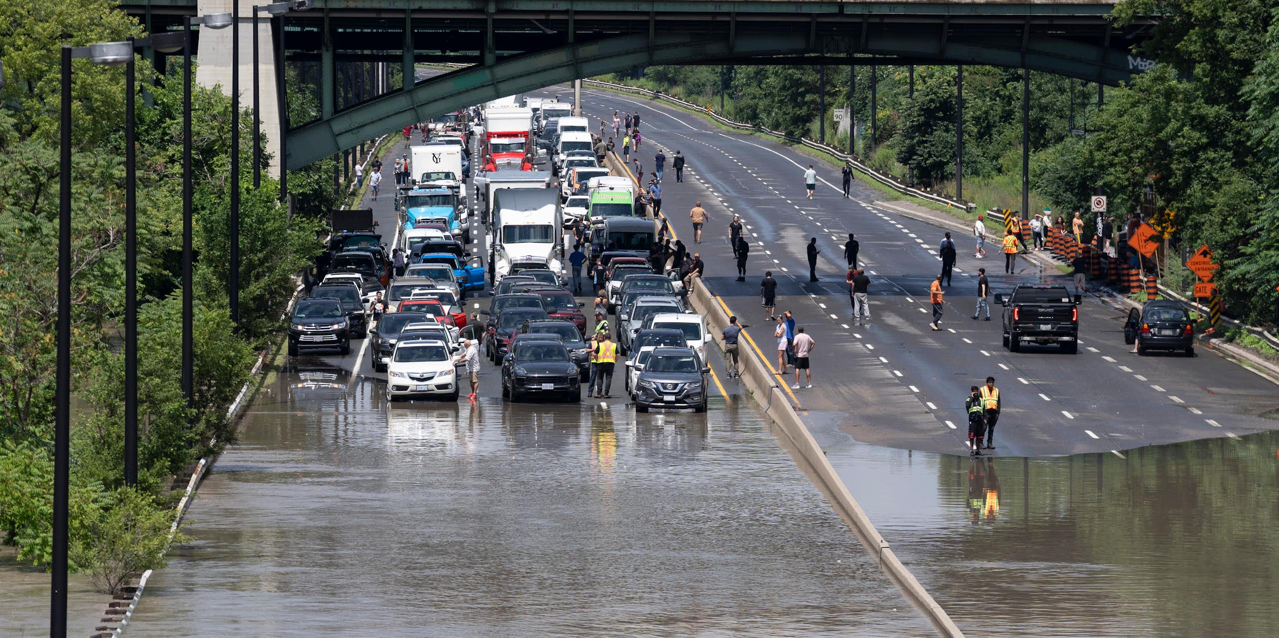 A back up of cars is seen on a flooded highway.