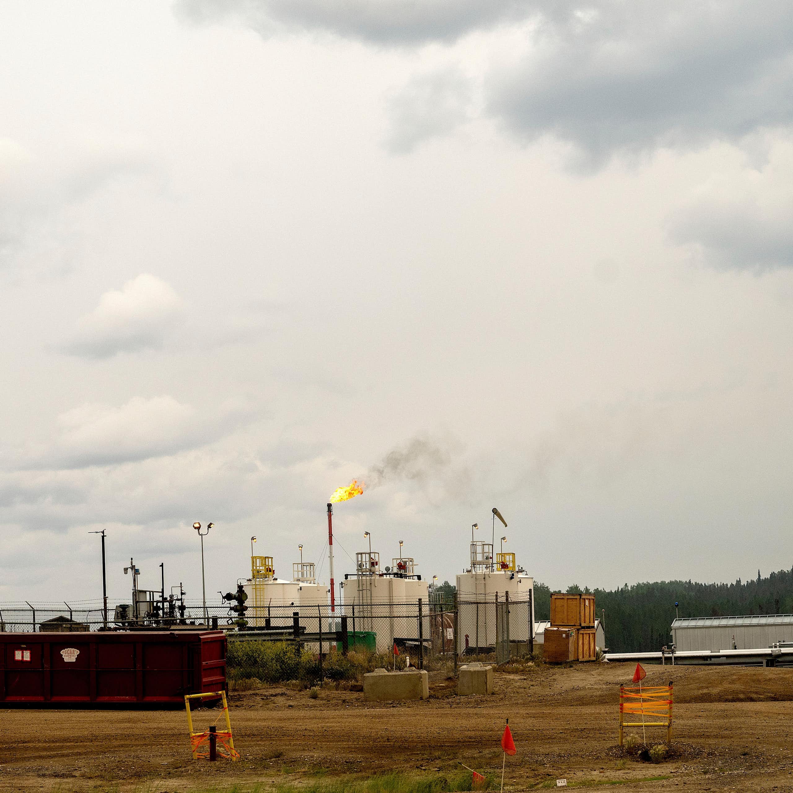 Flames rise out of a smokestack in a gas plant.
