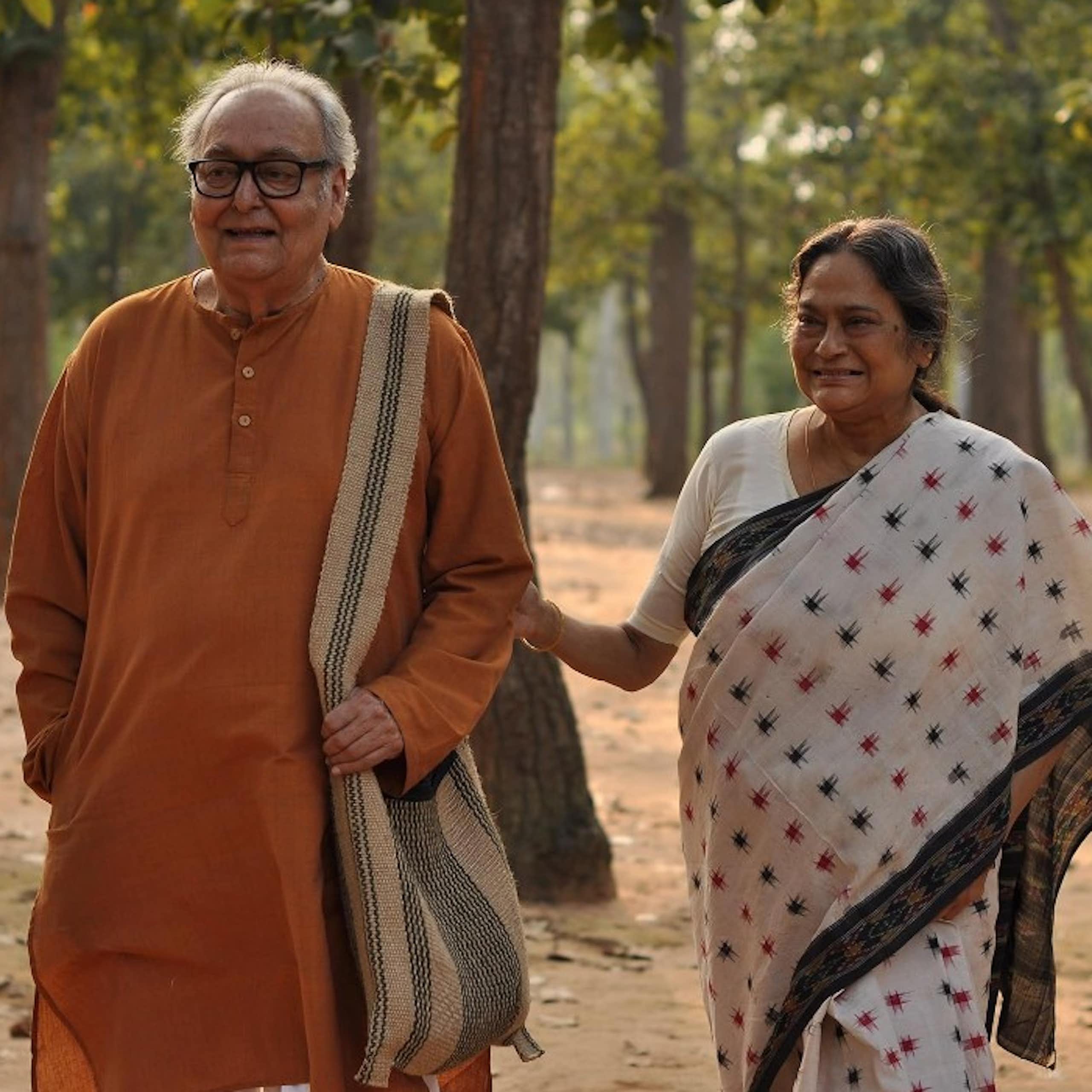 An elderly couple holding hands.
