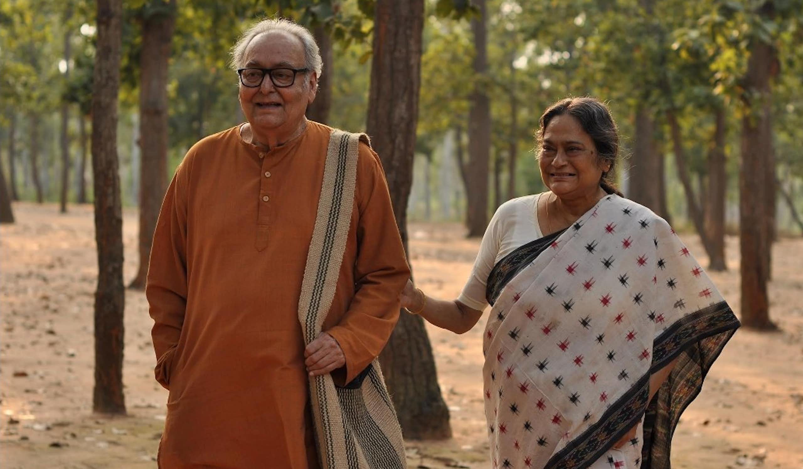 An elderly couple holding hands.