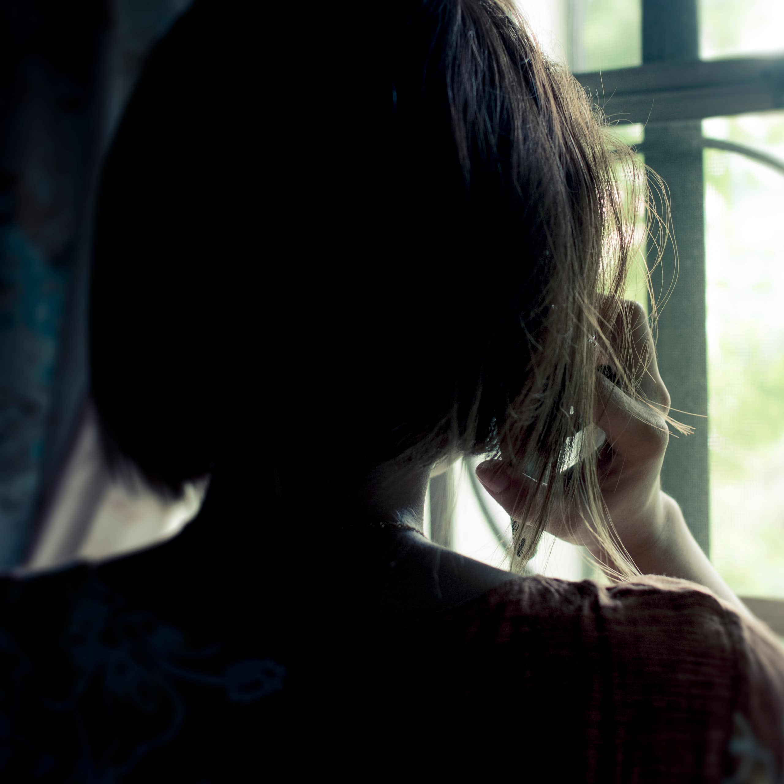 The back of a woman's head seen in silhouette.