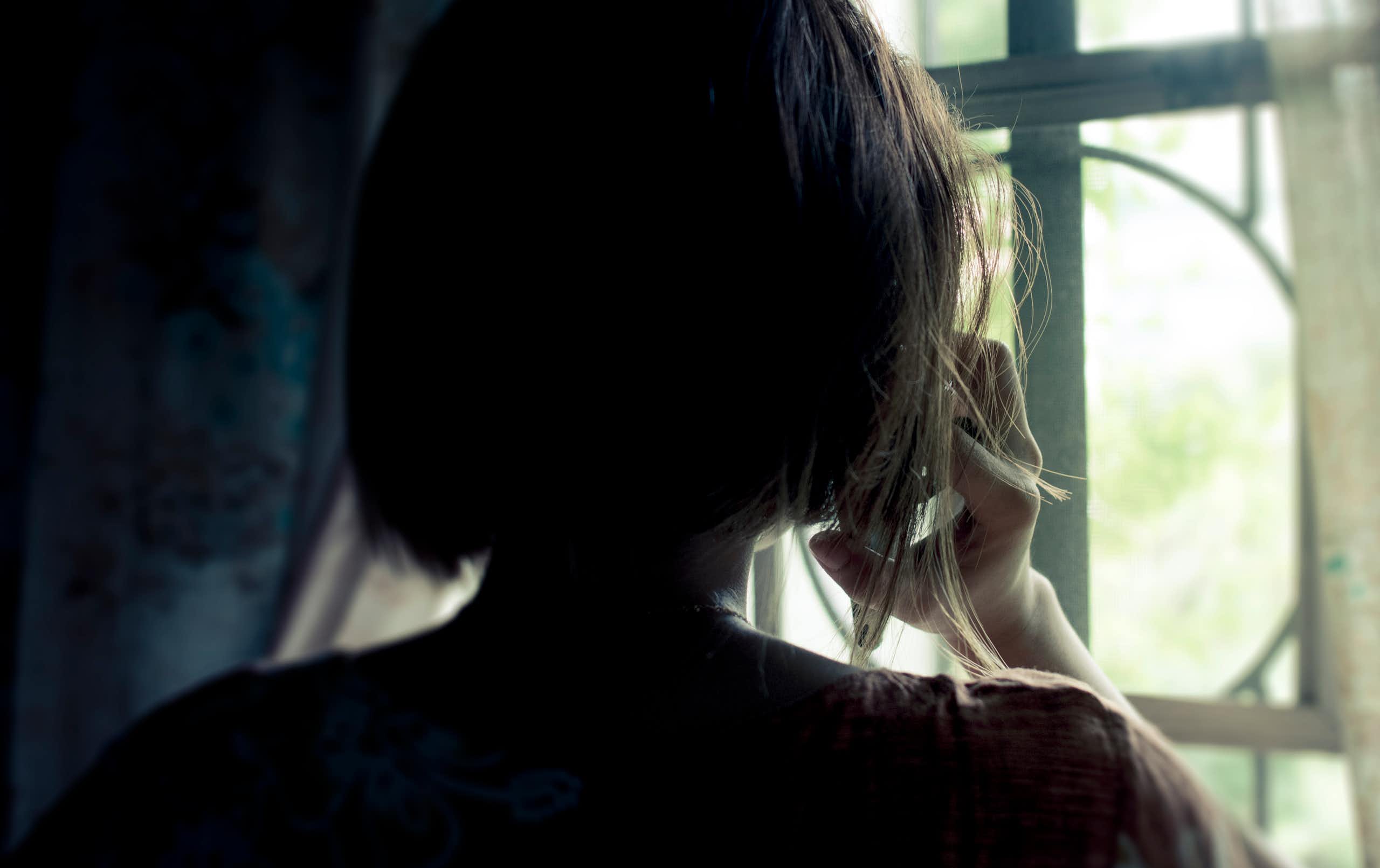 The back of a woman's head seen in silhouette.
