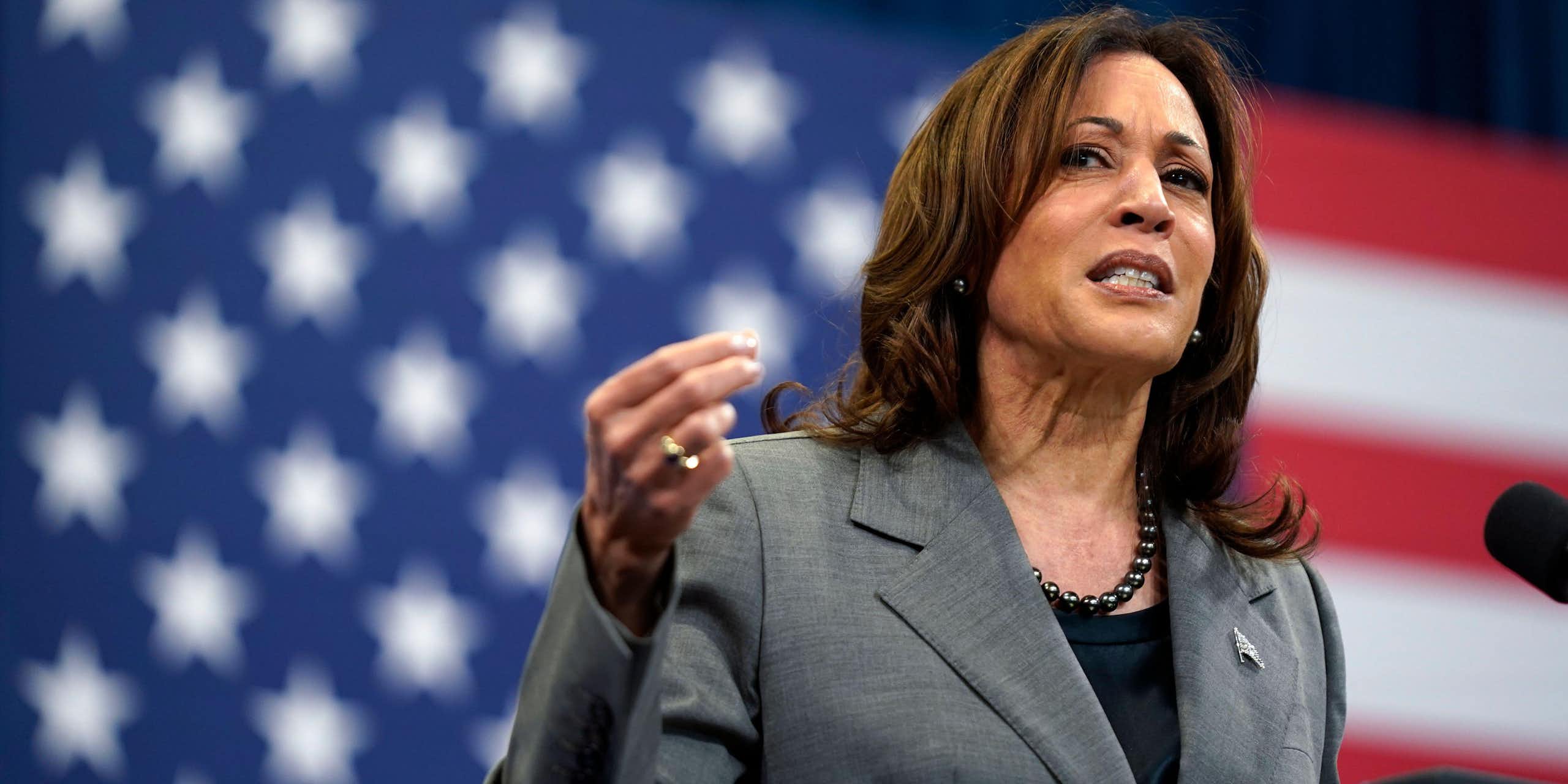 Kamala Harris at a podium in front of a US flag.