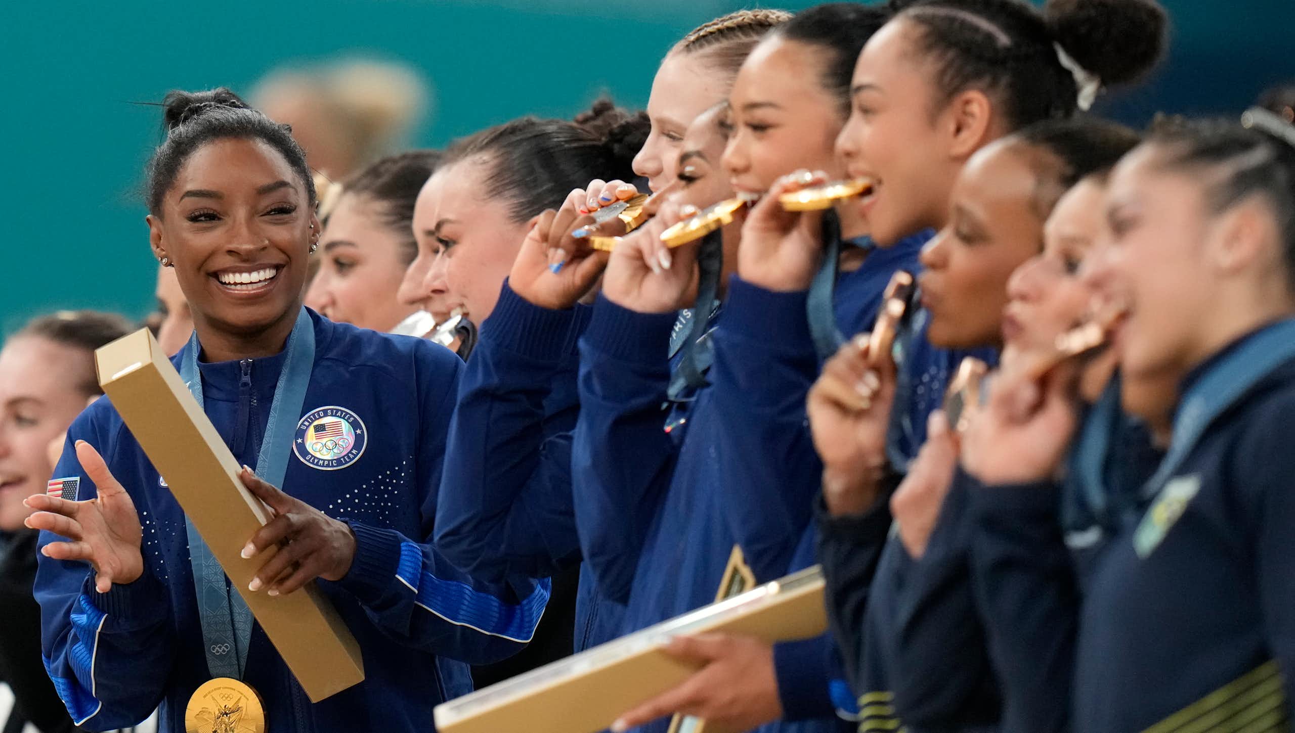 Simone Biles and her US team celebrate after winning gold in Paris.