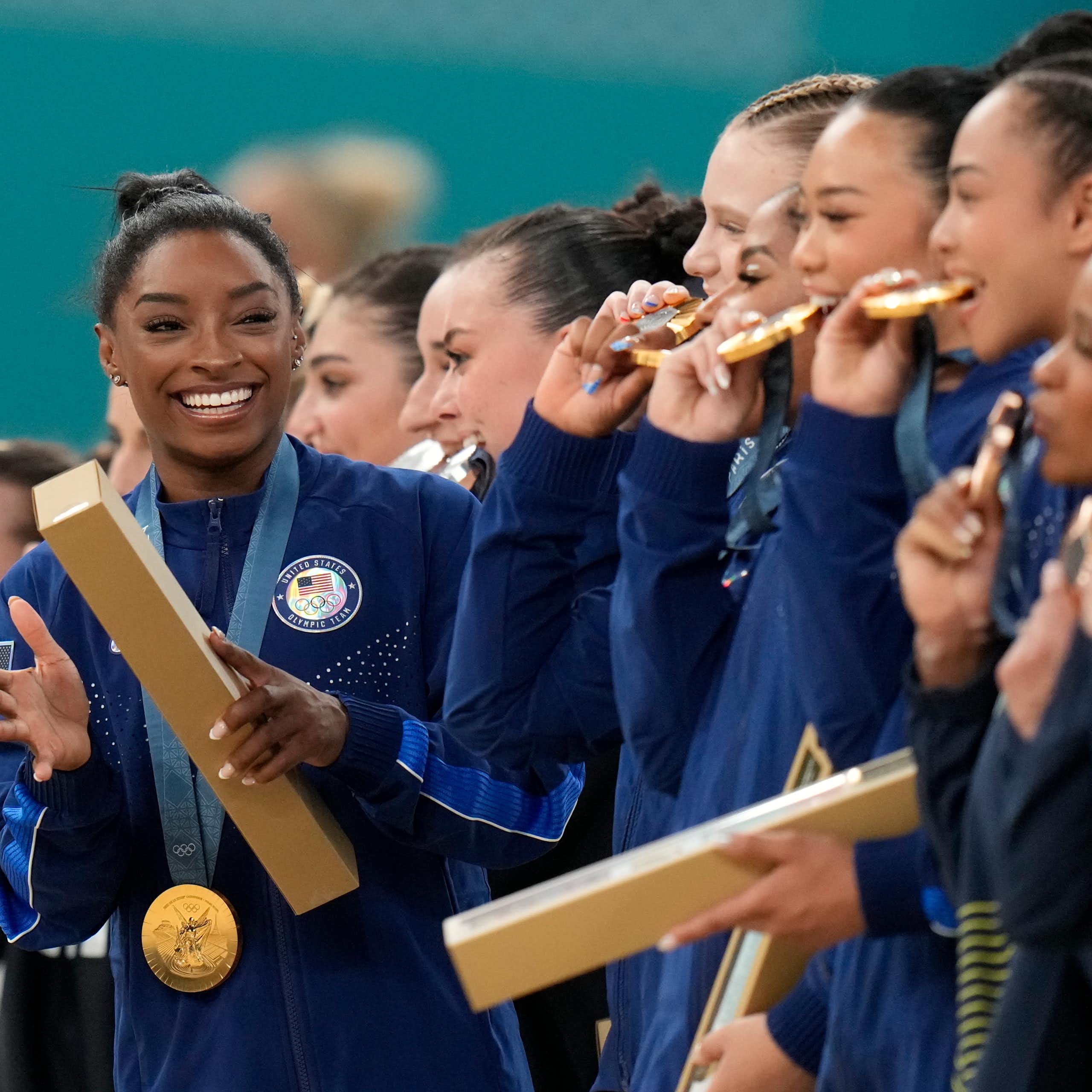 Simone Biles and her US team celebrate after winning gold in Paris.