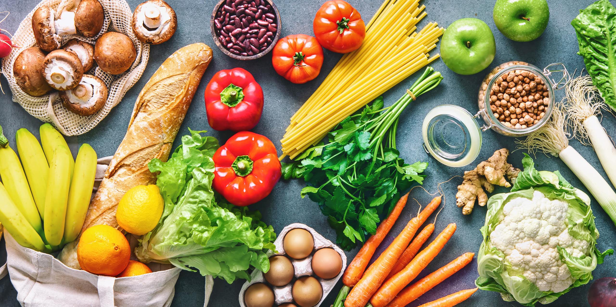 An array of fresh fruit, vegetables, bread and eggs.