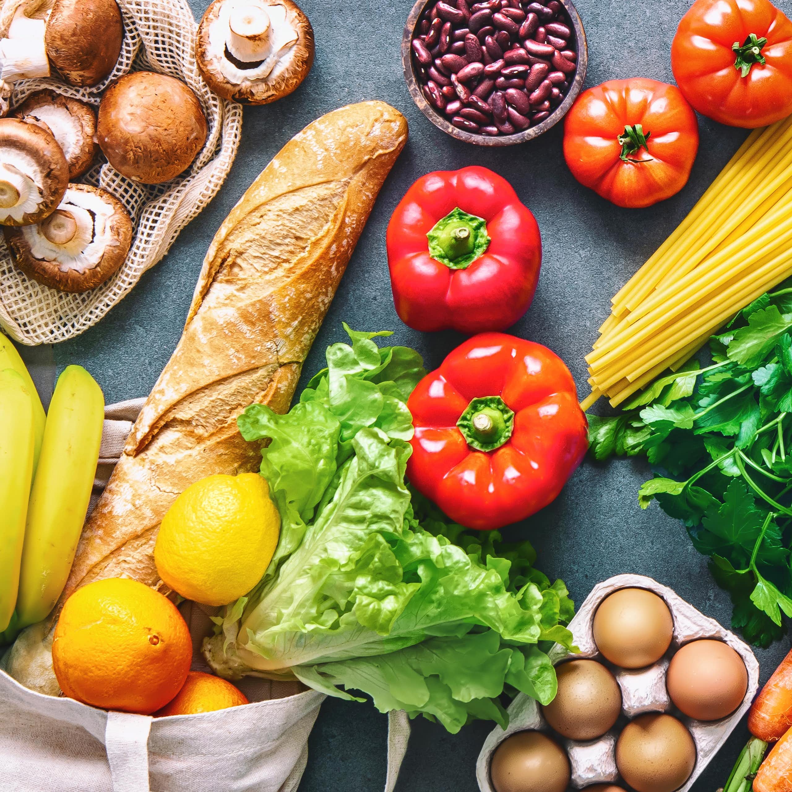 An array of fresh fruit, vegetables, bread and eggs.