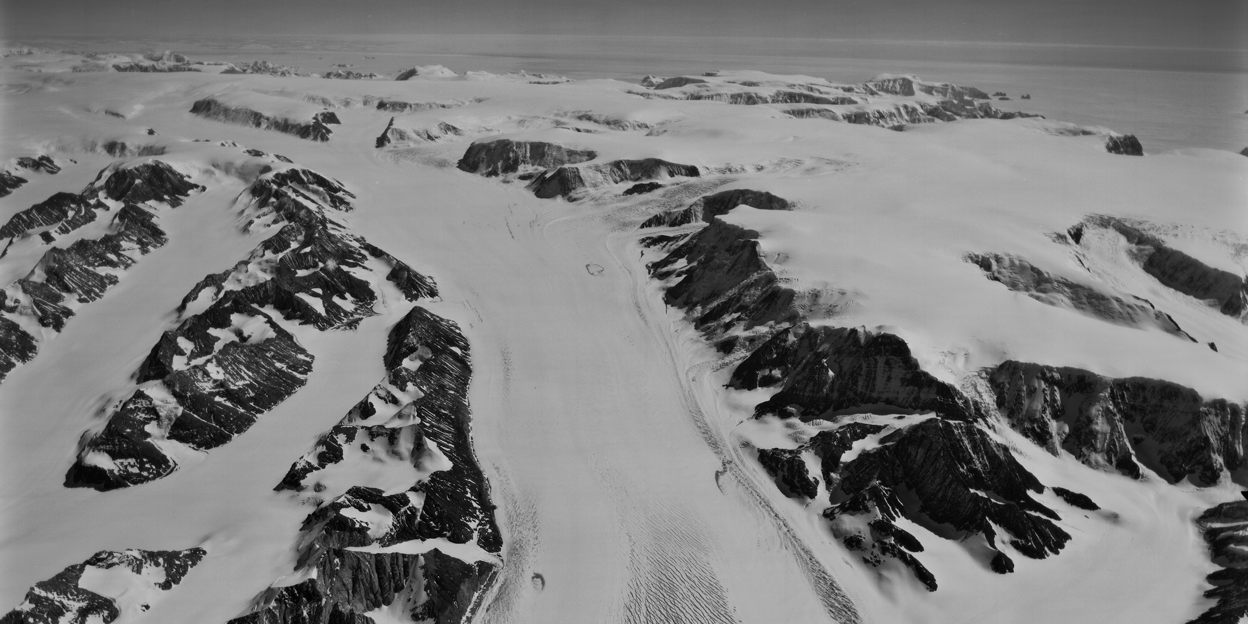 Black and white film photo of a glaciated mountain landscape.