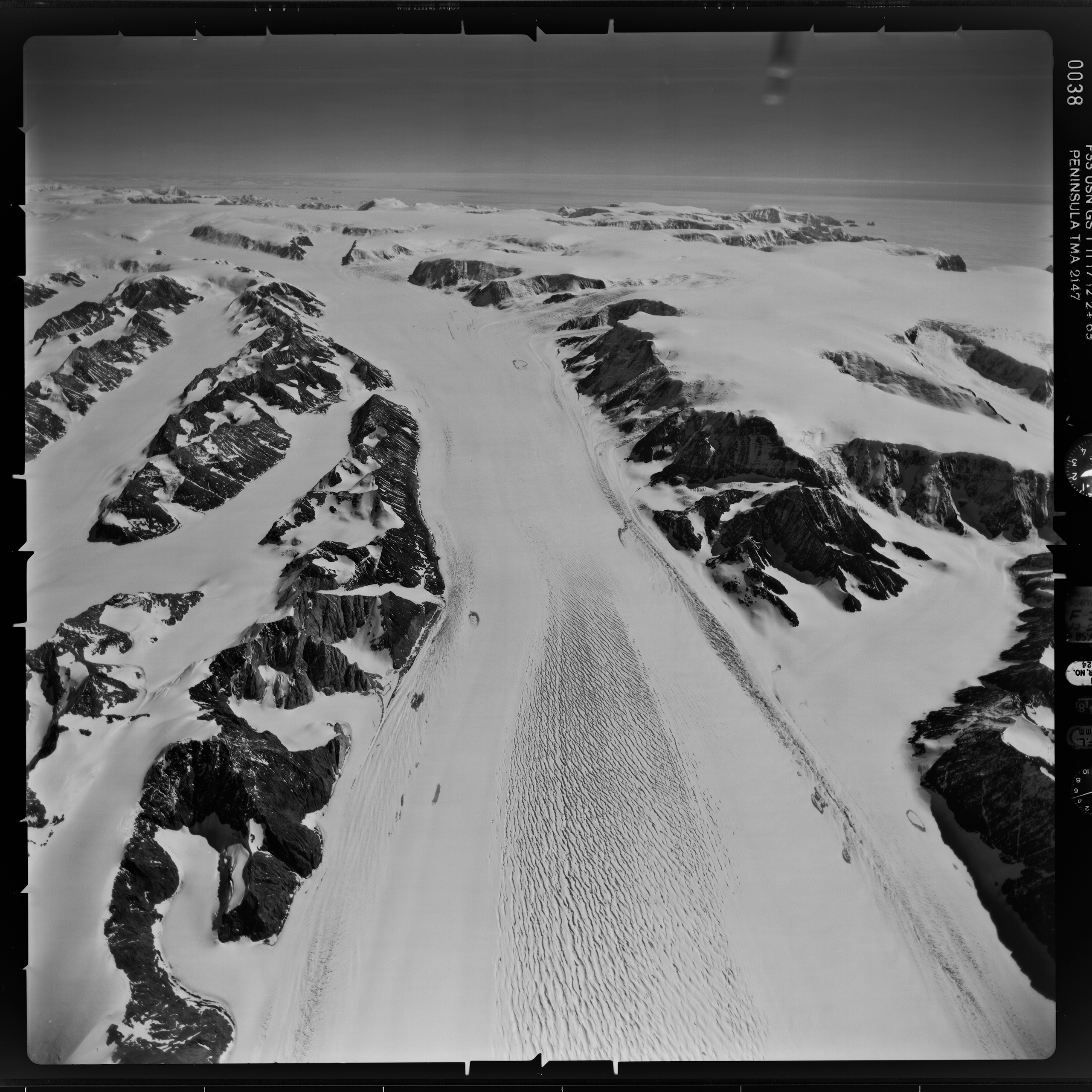 Black and white film photo of a glaciated mountain landscape.